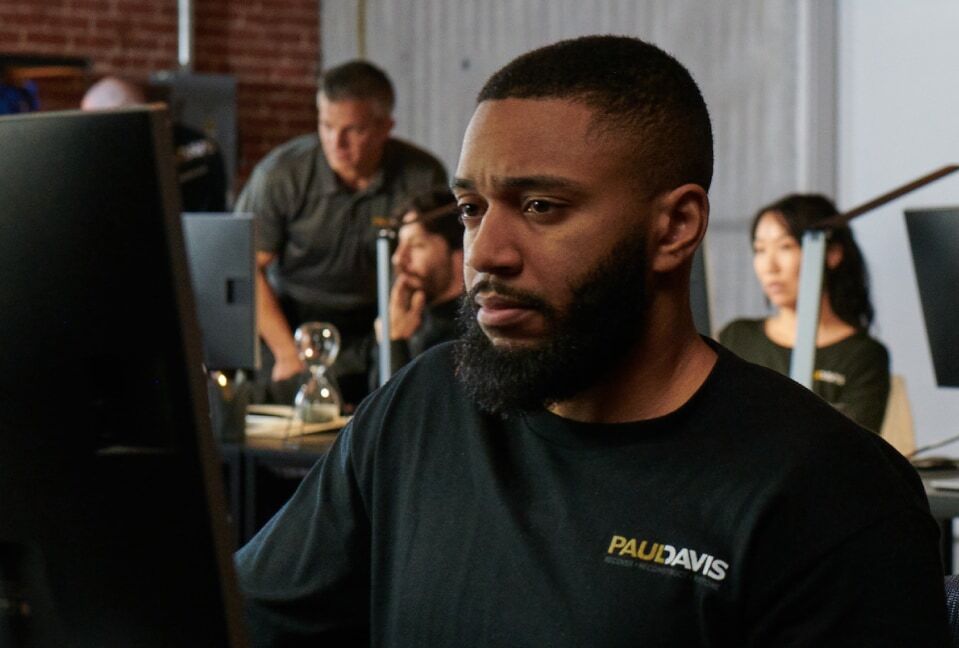 Paul Davis Restoration team member working at a computer in the office